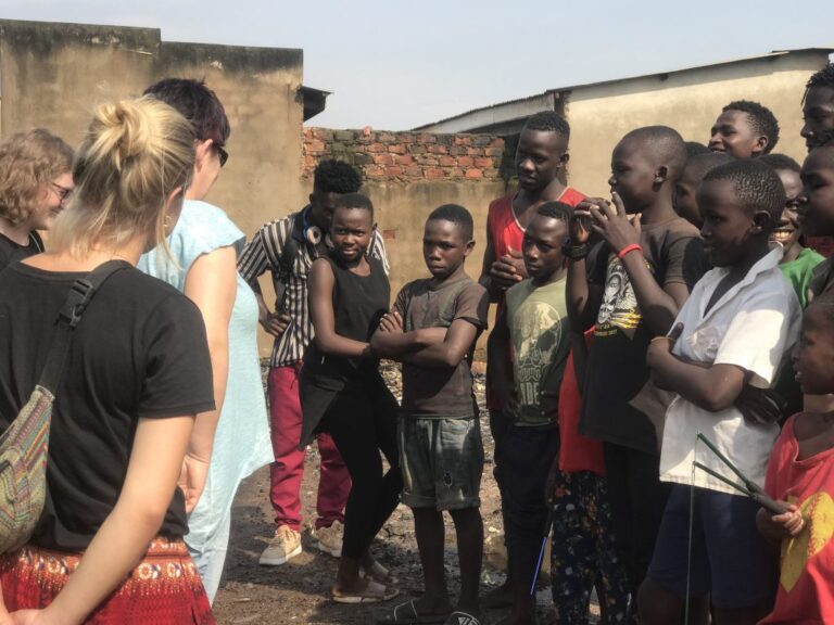 Volunteer and students talking in a semicircle