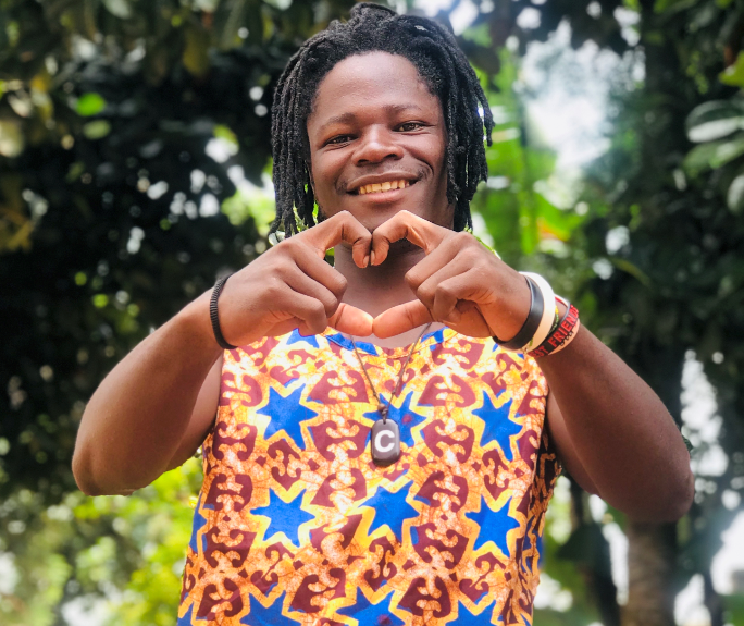 Student creating a heart with his hands